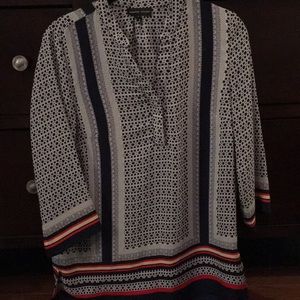 A super cute patterned blouse with an open v-neck!